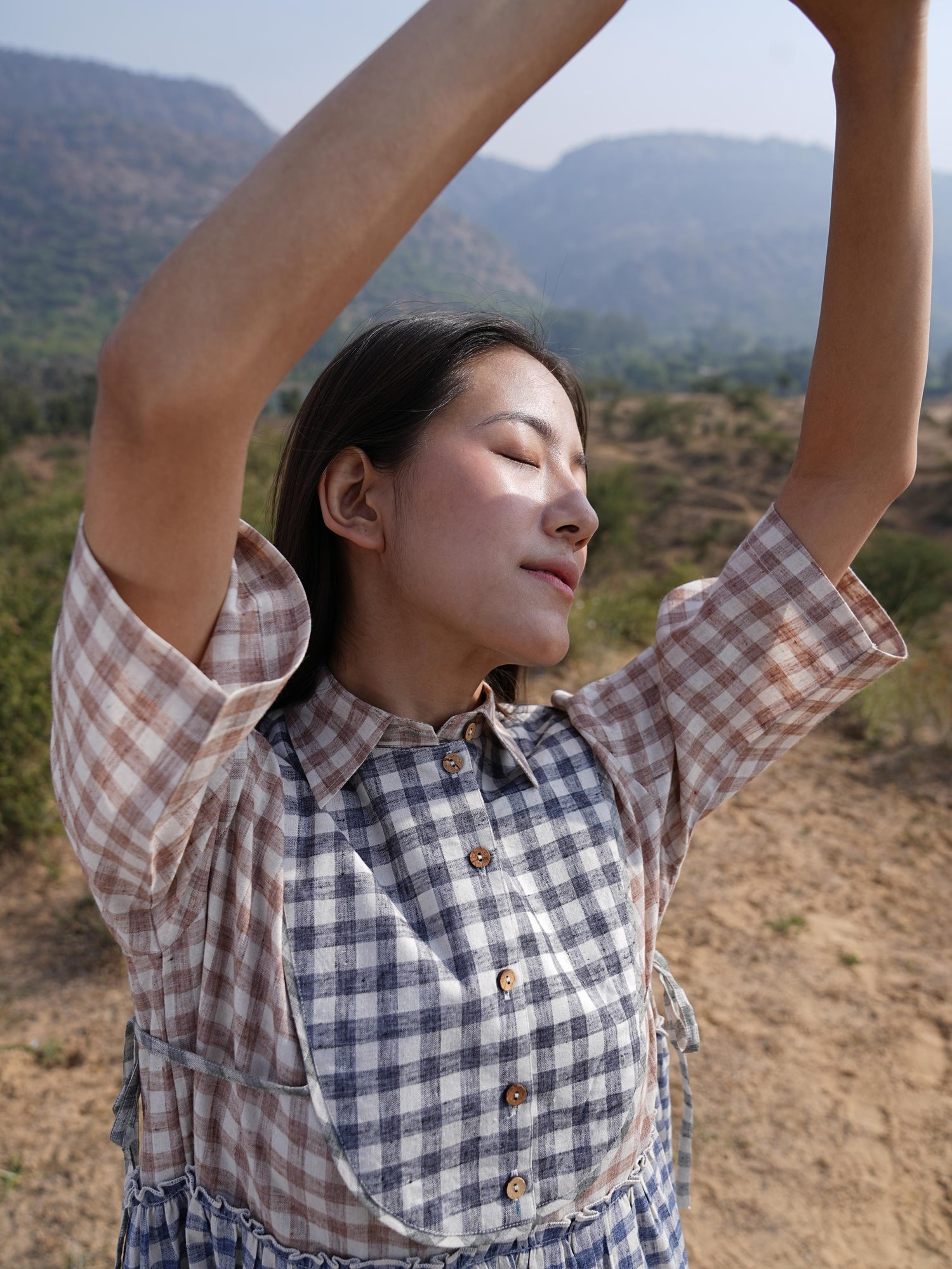 Side profile of the checked cotton maxi dress, showing its relaxed drape