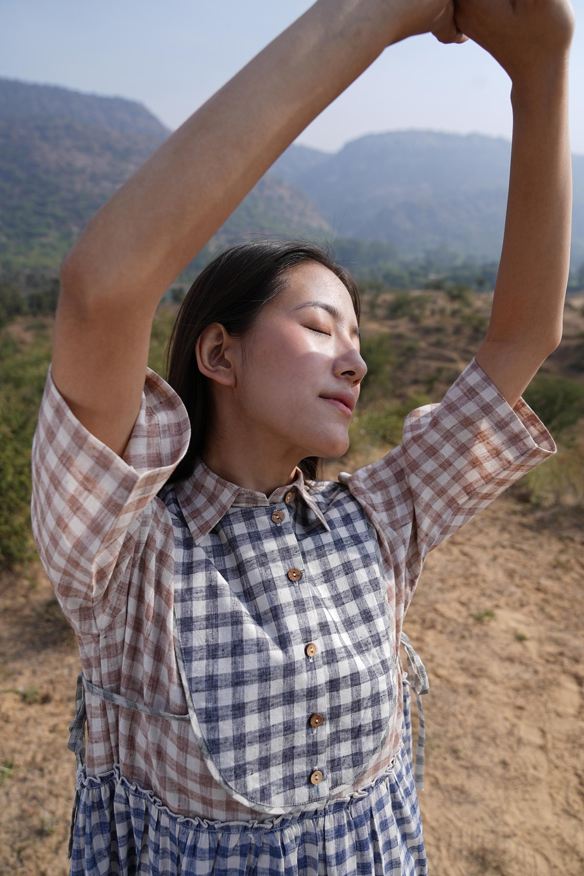 Side profile of the checked cotton maxi dress, showing its relaxed drape