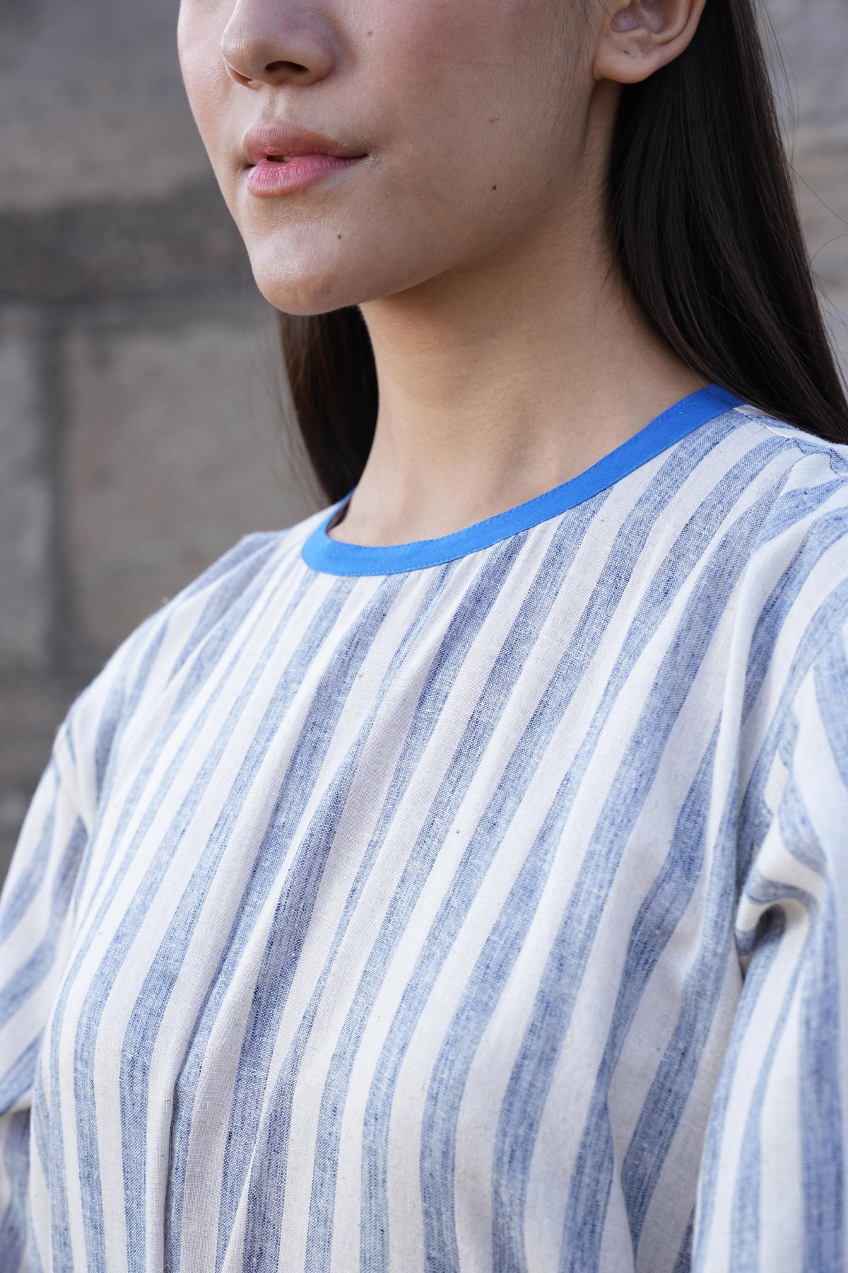 Detail of the clean French-seam finish on the striped cotton dress