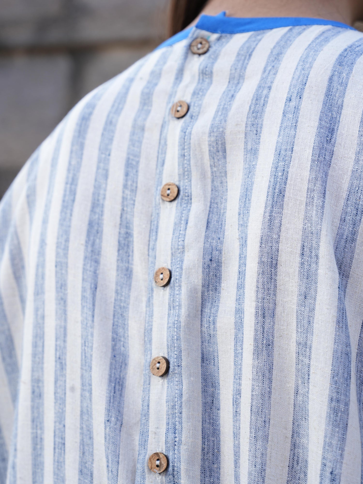 Model styling the striped cotton dress for a warm summer day