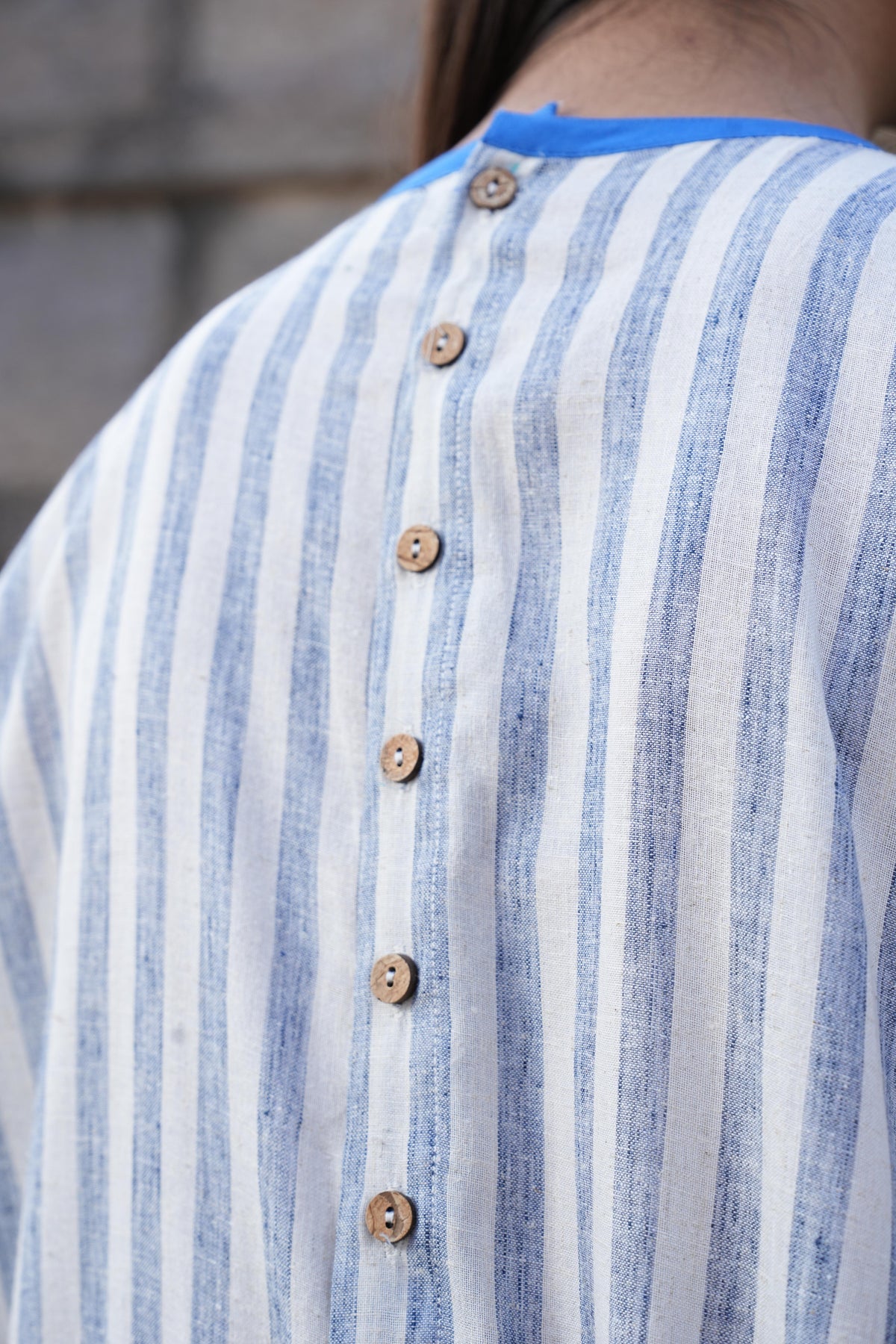 Model styling the striped cotton dress for a warm summer day
