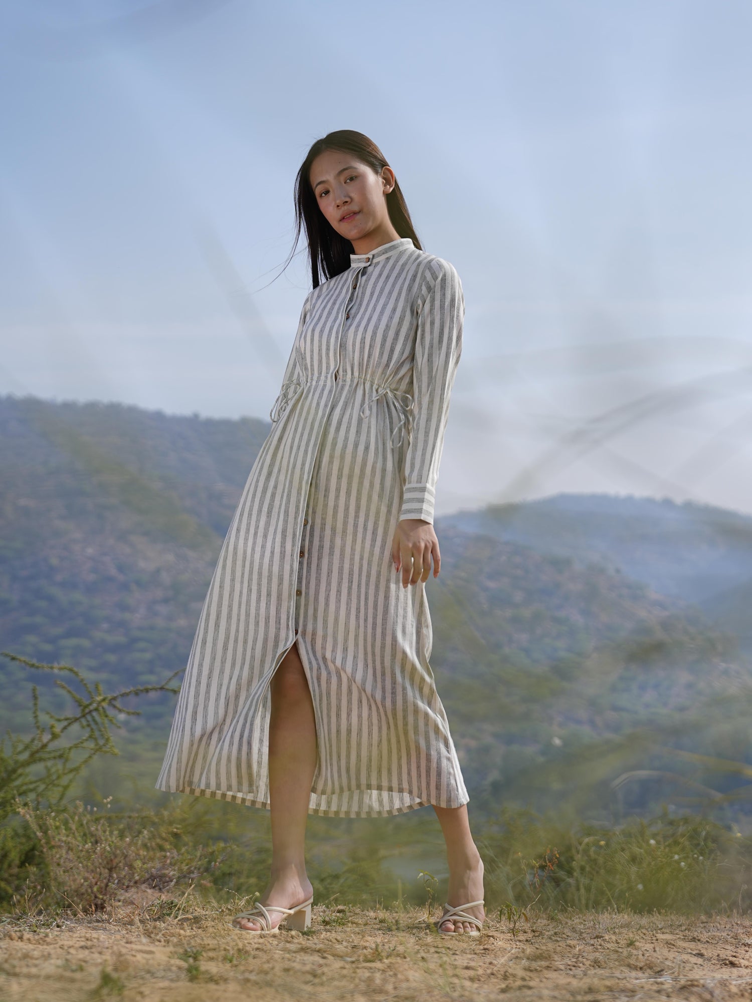 Side profile of the striped cotton maxi dress, showing its relaxed drape