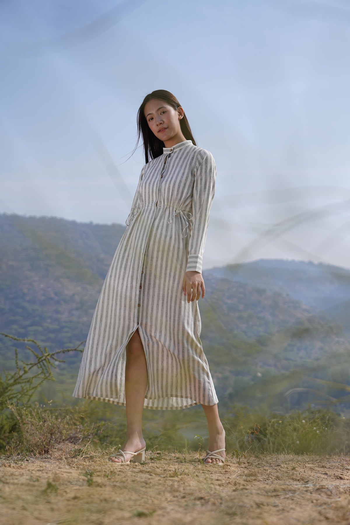 Side profile of the striped cotton maxi dress, showing its relaxed drape